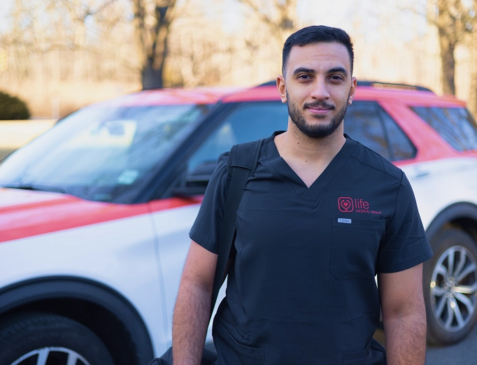 A Life Mobile Care healthcare professional standing in front of a branded medical SUV, prepared for a mobile patient visit