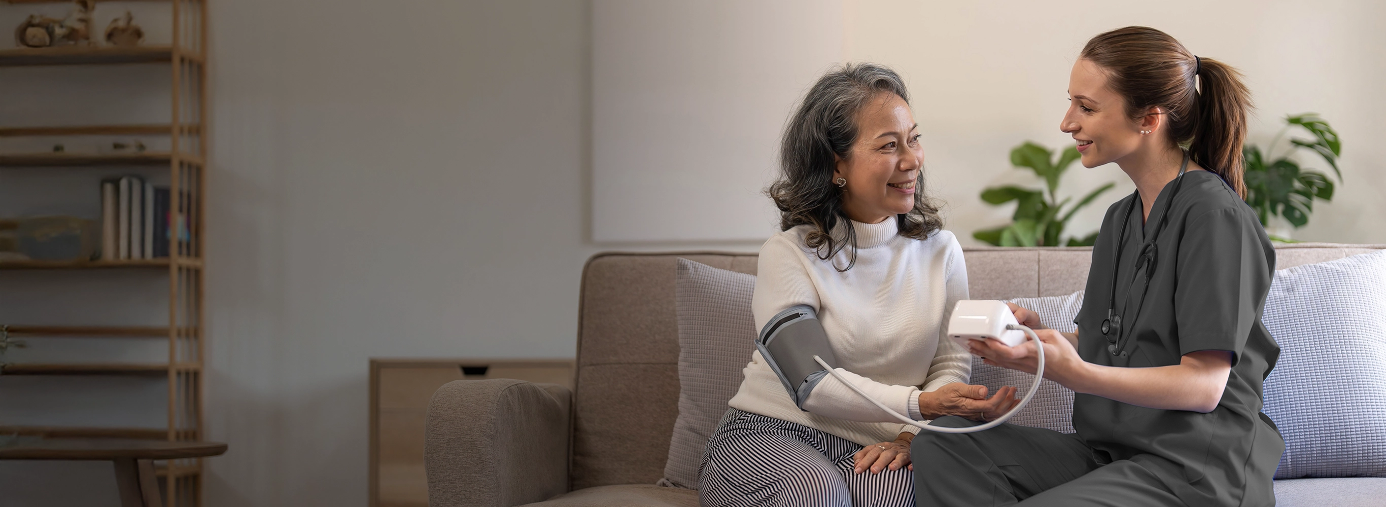 Nurse providing at-home chronic care support, helping a senior patient manage their health.